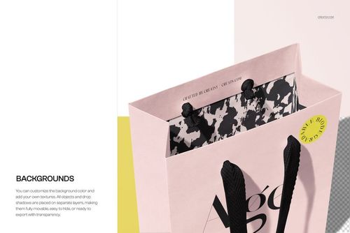 Paper shopping bag mockup in soft pink, featuring black handles and a monochrome abstract interior, viewed from above.