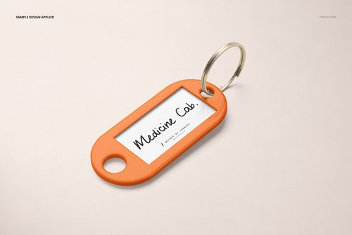 Front view of a rectangular orange key tag mockup with a silver ring and a white label insert on a neutral background.