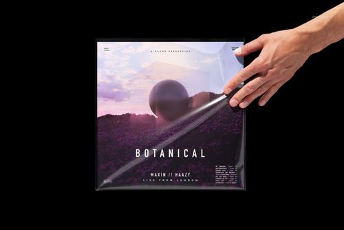 Front view of a vinyl record mockup showing a hand lifting clear plastic over a colorful scenic album cover.