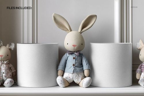 Mockup of kids room drum lampshades in neutral colors, displayed with a plush bunny toy on a white shelf.