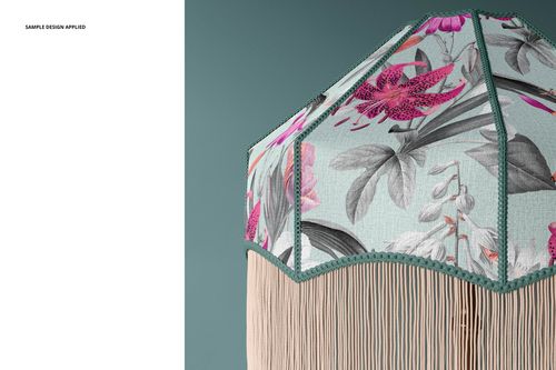 Table lamp mockup featuring a decorative shade with pink flowers, gray leaves, and green trim against a teal wall.
