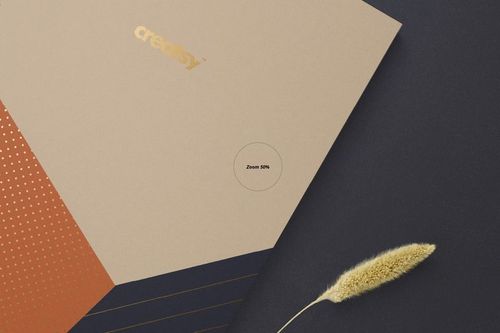 A5 spiral notebook mockup with square corners, featuring beige and copper geometric cover on dark background.