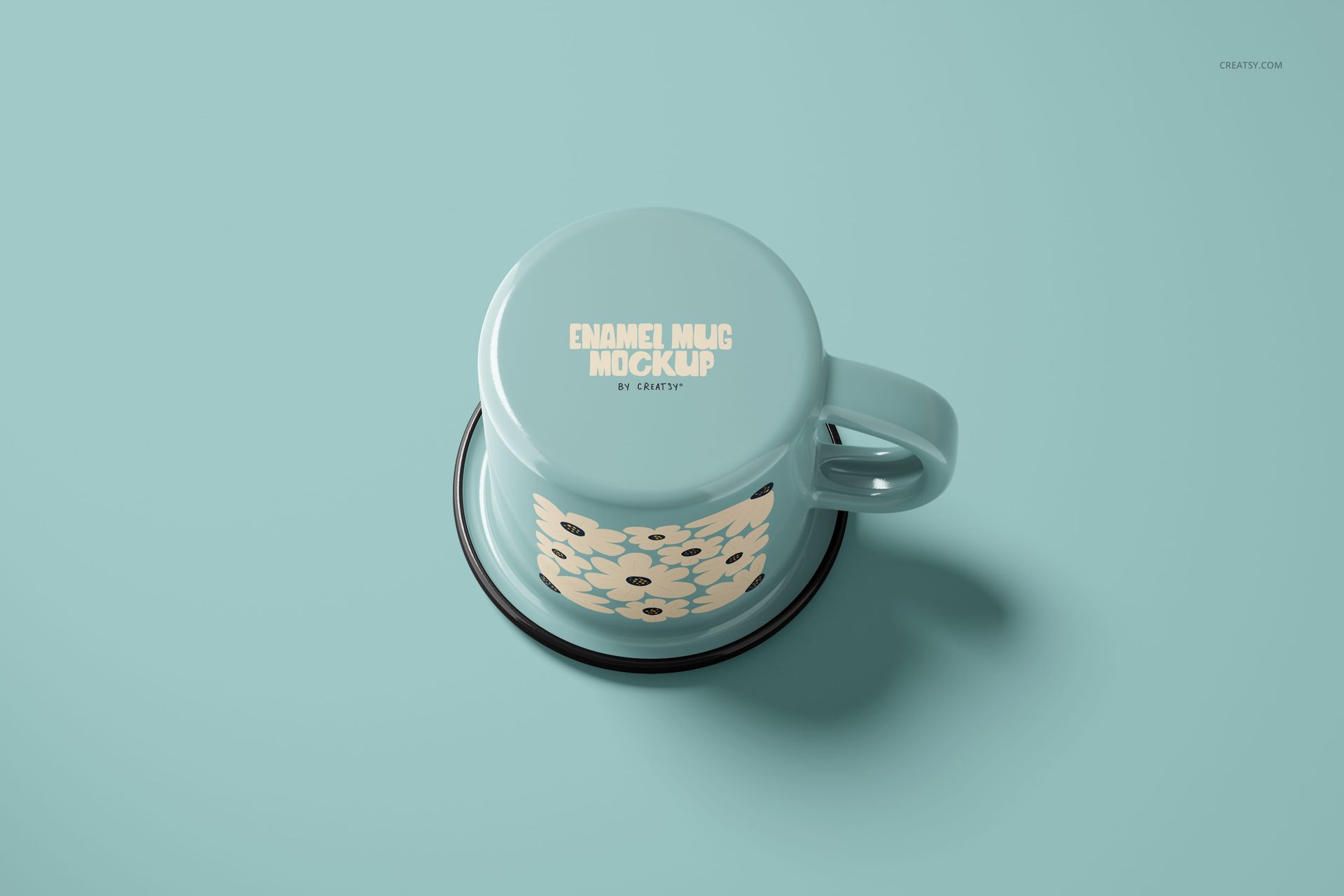 Light blue enamel mug with cream floral pattern, displayed upside down on matching blue surface, front view.