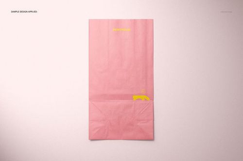 Front view of a pink lunch bag with a yellow printed design, shown on a light background in a packaging mockup.
