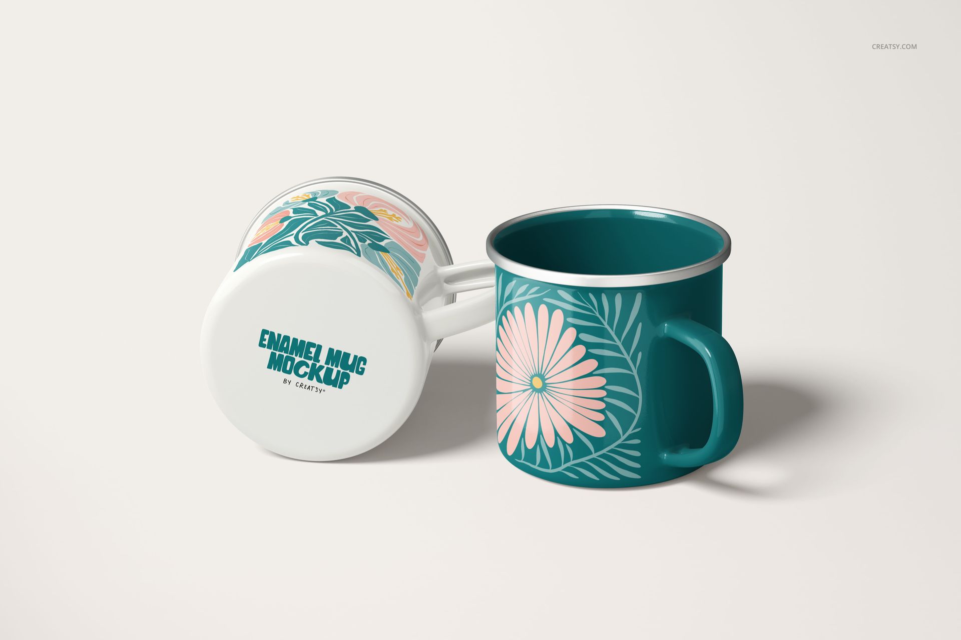PSD mockup showing a pair of 360ml enamel mugs, decorated with large pink flowers and teal leaves on a light surface.