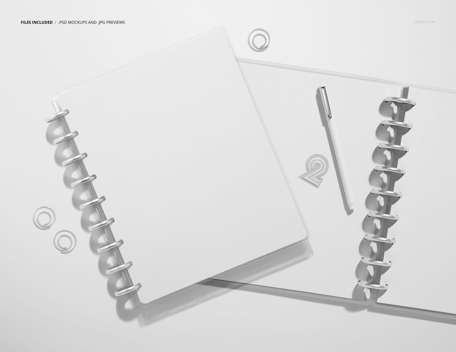 PSD mockup showing two blank spiral planners from above, with a pen and loose rings placed nearby.