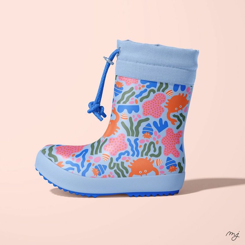Rain boots mockup featuring a single blue boot with colorful sea creature patterns, shown on a light peach background.