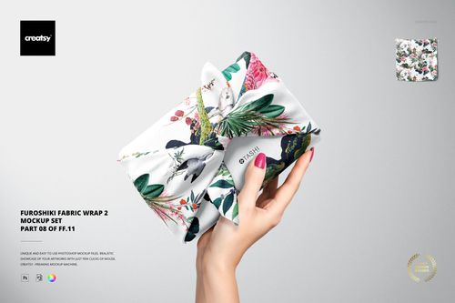 Furoshiki fabric wrap mockup with a vibrant floral and bird design, displayed in a hand against a light background.