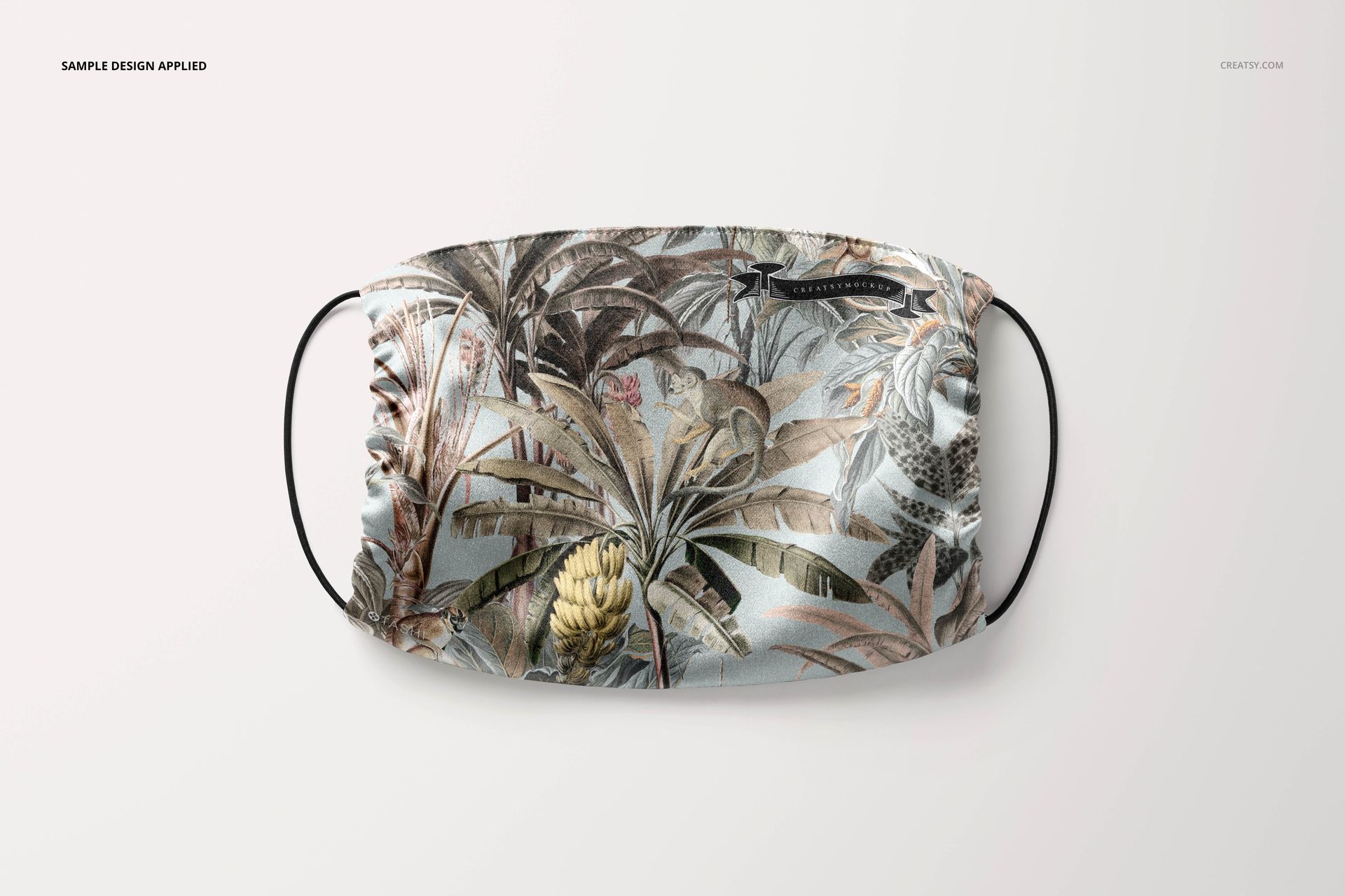 Silk face mask mockup featuring a detailed plant and foliage design, shown from above with elastic ear straps.