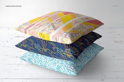 PSD mockup set displaying three decorative pillows with unique designs, arranged in a neat pile against a light background.