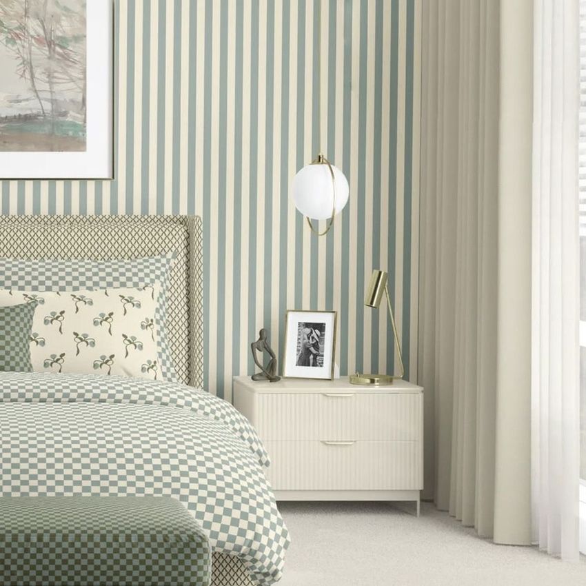 Bedroom scene bedding mockup featuring a checkered bedspread and floral pillows, striped wallpaper, and a modern nightstand.
