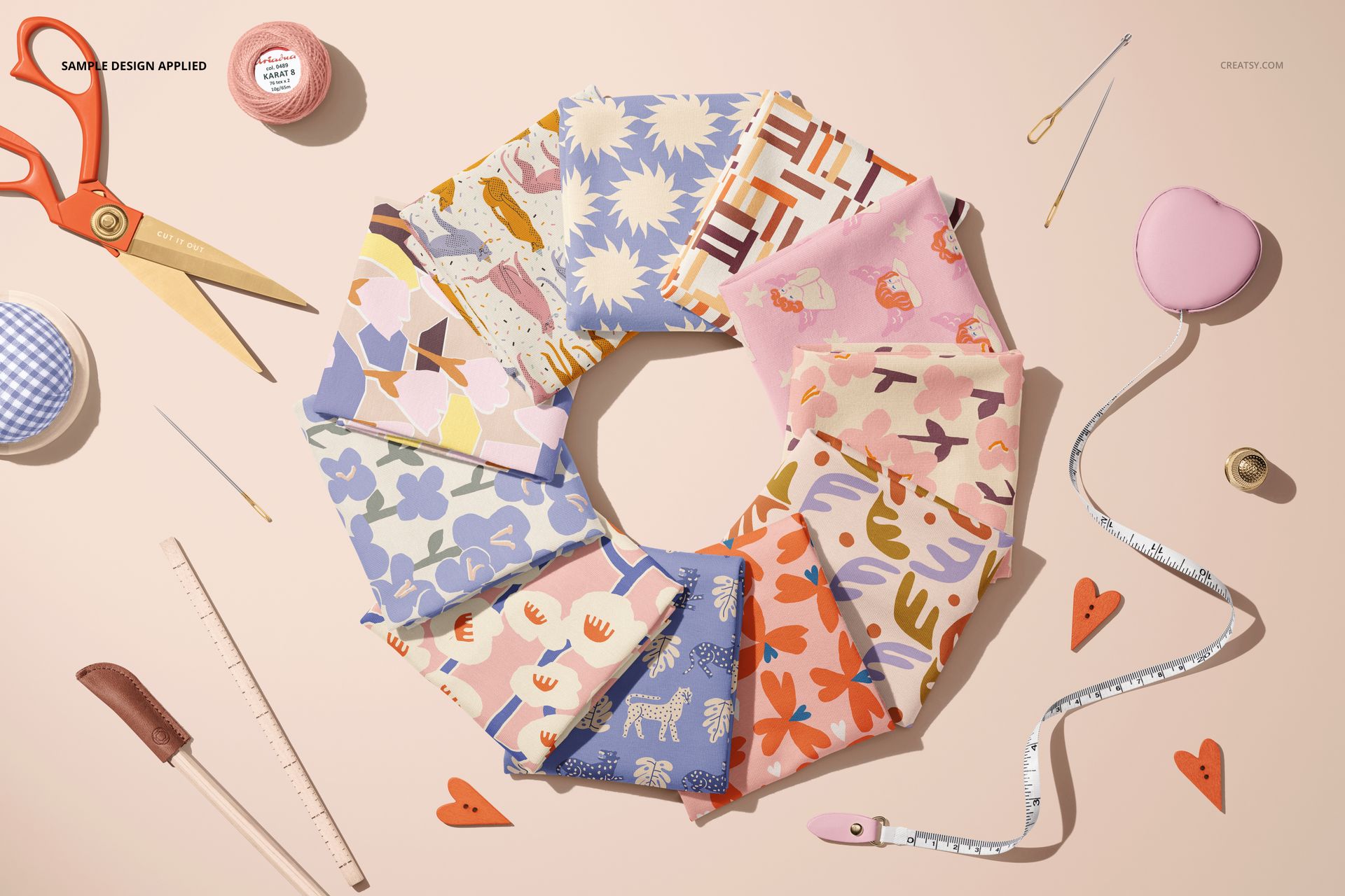 Top view of colorful jersey fabric pieces arranged in a circle, each with different patterns on a light surface.