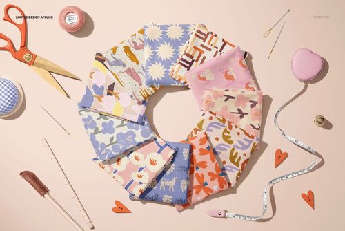 Top view of colorful jersey fabric pieces arranged in a circle, each with different patterns on a light surface.