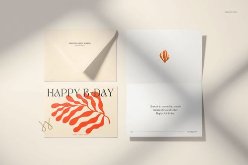 Greeting card mockup set featuring a 5x7 card and envelope on a light surface, with orange leaf design and shadows.