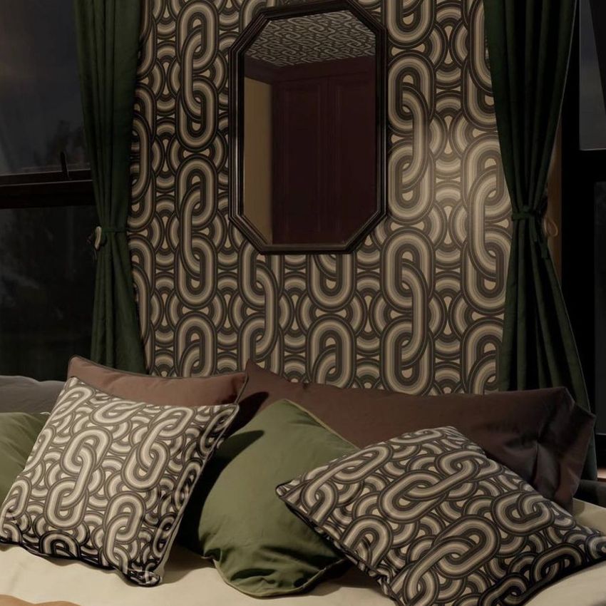 Bedroom mockup scene showing a bed with green and beige pillows, dark green curtains, and geometric patterned wallpaper.