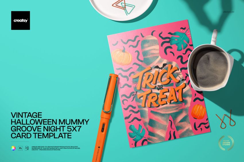 Halloween-themed 5x7 card mockup featuring bold orange and pink graphics, shown with stationery and coffee cup props.
