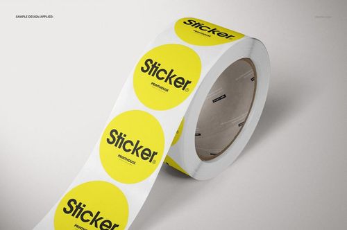 PSD mockup of a roll of round stickers featuring yellow circles with bold black lettering, displayed on a light surface.