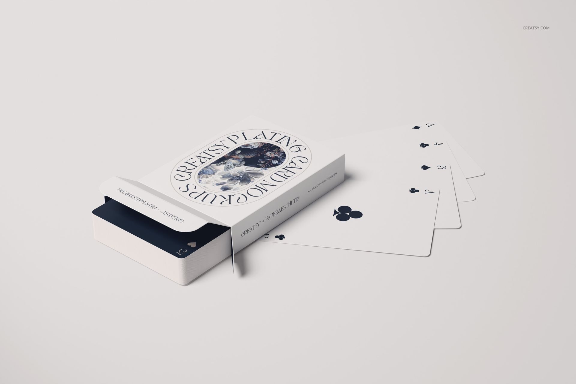 Playing cards mockup featuring an open card box with several cards fanned out on a light surface, front view.