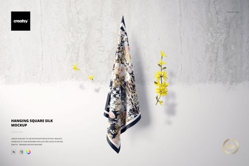 Front view of a hanging square silk scarf mockup featuring a mix of floral and leopard patterns on a pale wall.