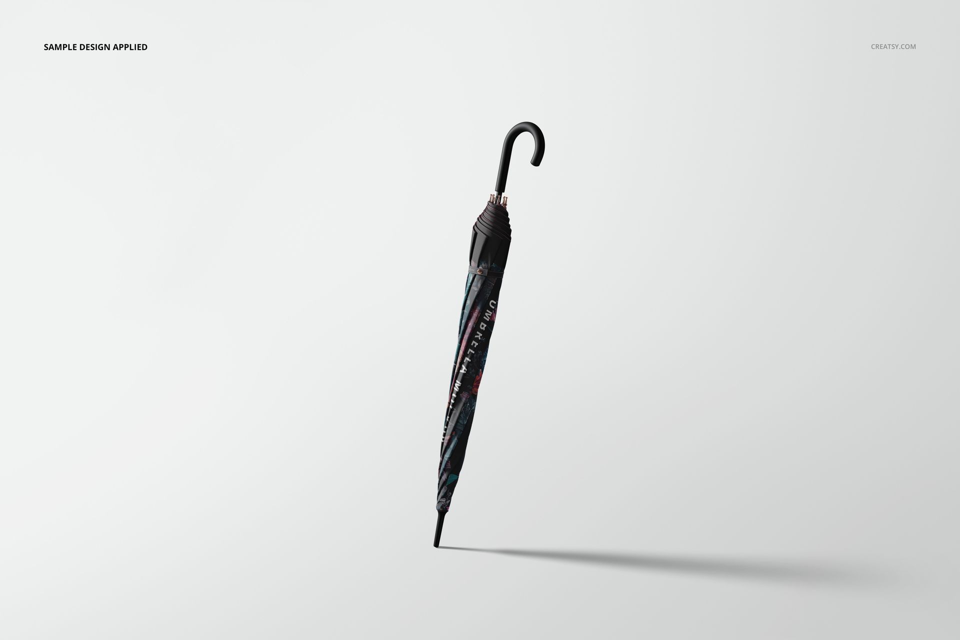 Closed umbrella mockup with a curved black handle, featuring a dark patterned design, shown on a light background.
