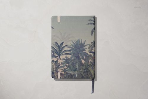 Leather notebook with tropical palm pattern, shown from above on a light marble surface, PSD mockup stationery.