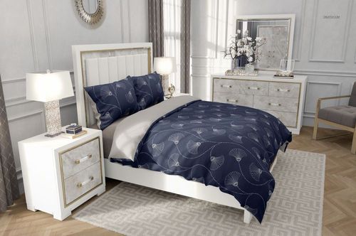 Modern bedroom with a white bed frame, navy blue patterned bedding, two pillows, and light wood furniture.