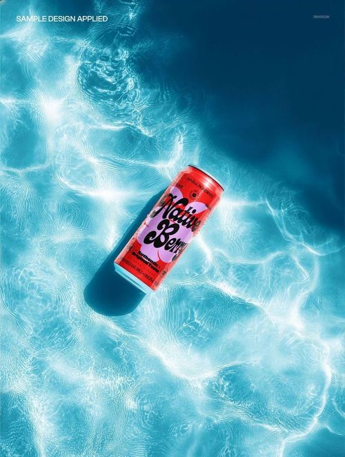 PSD mockup of a tall soda can featuring a colorful label, shown floating in bright blue swimming pool water.
