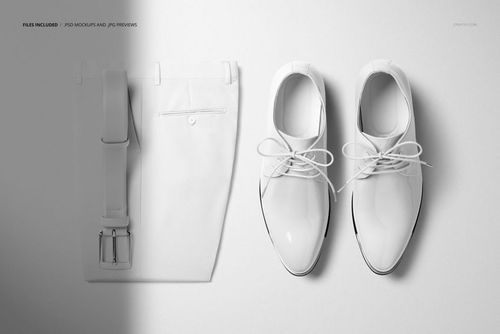 Men’s trousers with a leather belt and a pair of oxford shoes arranged on a flat white surface, top view mockup.