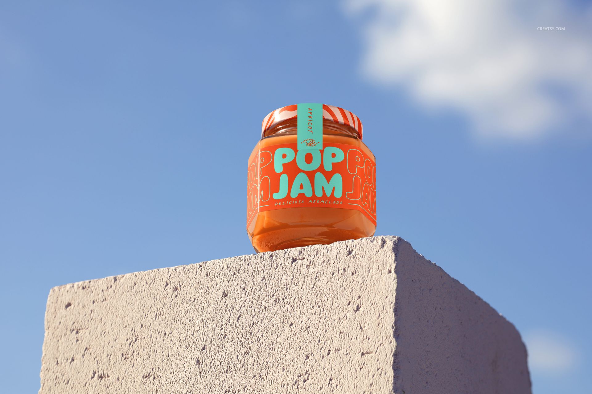 Front view of a persimmon jam jar mockup featuring a bright orange label and teal lettering on a stone surface.