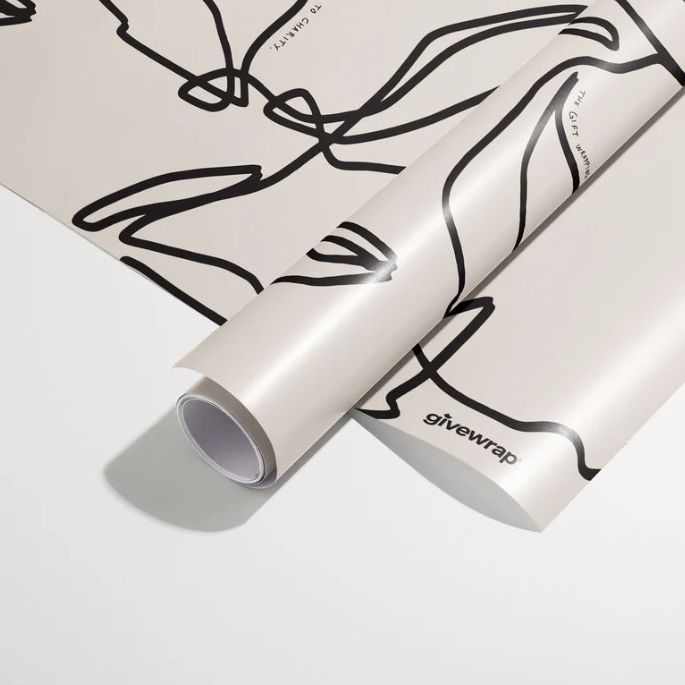 Gift wrapping paper mockup featuring two rolled sheets with abstract black line art on a light background, shown on a white surface.