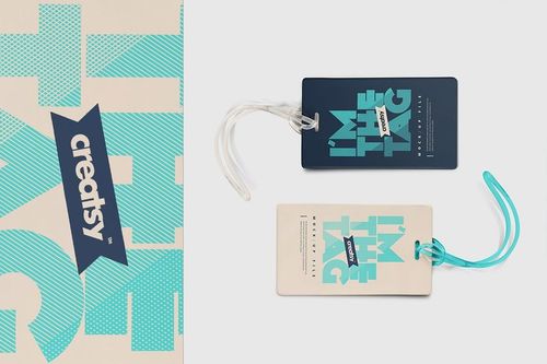 PSD mockup of two luggage tags with contrasting blue and beige colors, displayed flat with clear plastic loops.
