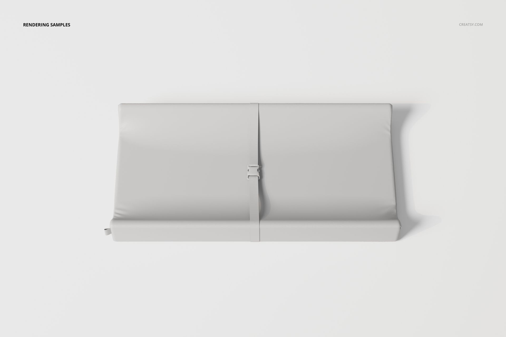 Contoured changing pad in light gray color, viewed from above, featuring a central safety strap on a white background.