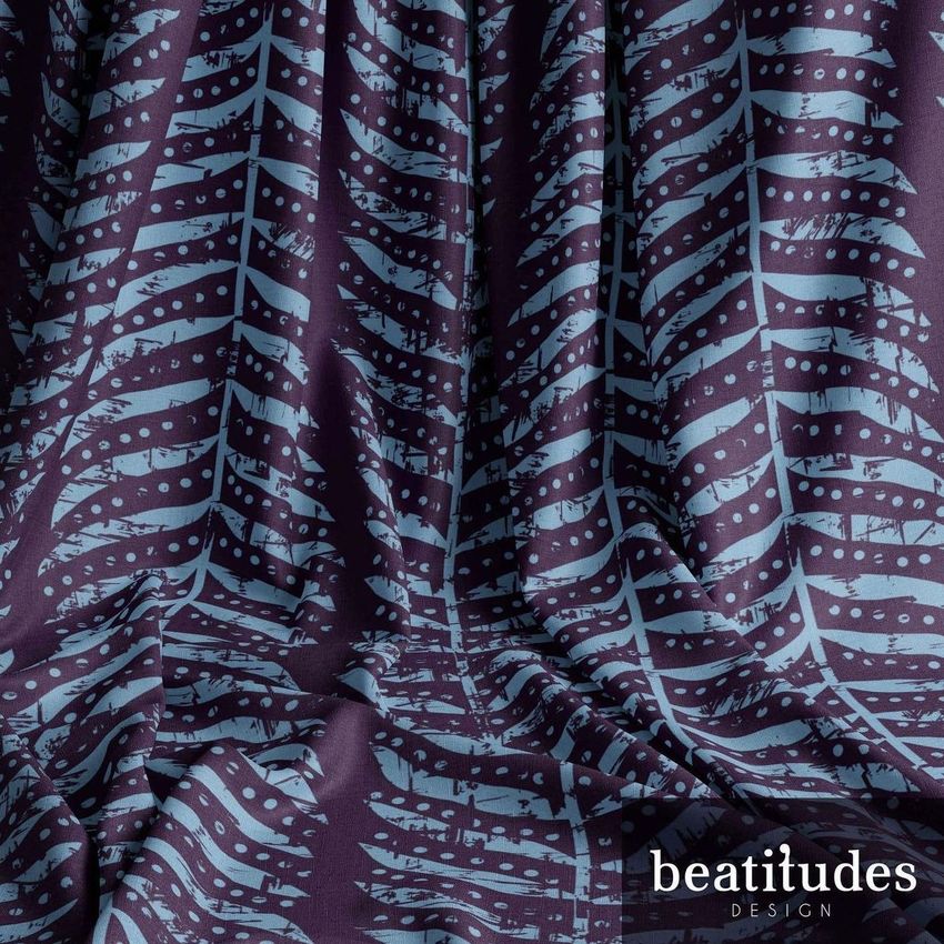 Draped fabric mockup featuring a blue fern leaf pattern on a dark purple background, with folds creating natural shadows.