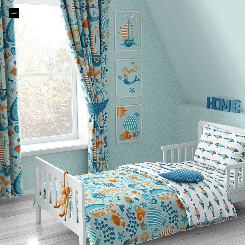 Toddler room bedding mockup showing a white bed with nautical-themed bedding in blue and orange, next to a window with matching curtains.