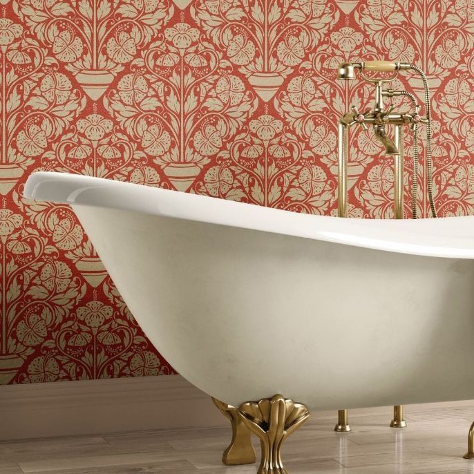 Victorian style bathroom mockup featuring a white clawfoot bathtub with gold fixtures against a red and beige floral patterned wallpaper.