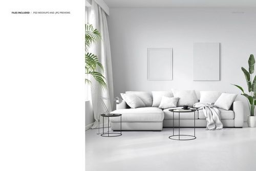 Modern living room with a white sofa, several white pillows, round black coffee tables, and green plants in a front view mockup scene.
