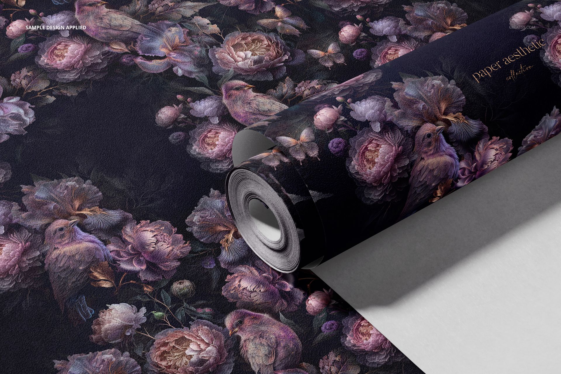 Close-up of a non-woven vinyl wallpaper mockup with purple flowers and birds, partially unrolled on a white surface.