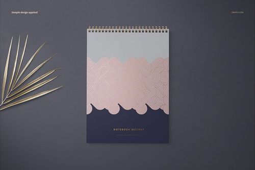 Front view of an A4 spiral notebook mockup with a geometric pink and gray design, placed on a dark surface.