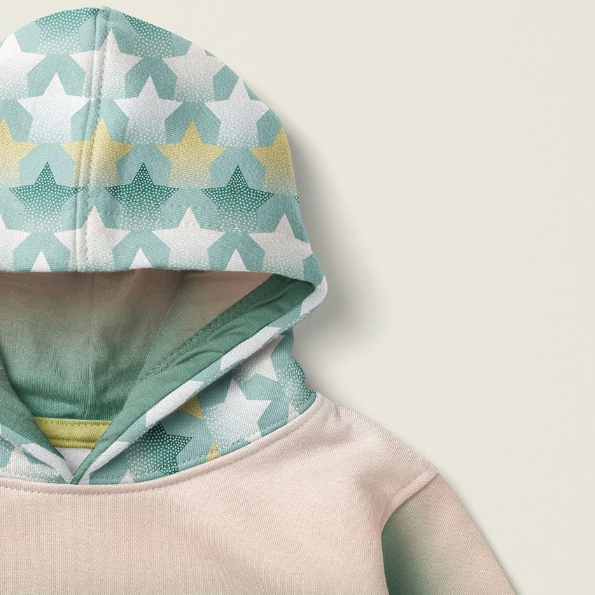 Kids pull on hoodie mockup featuring a pastel star pattern on the hood, shown from an angled top-down view on a light background.