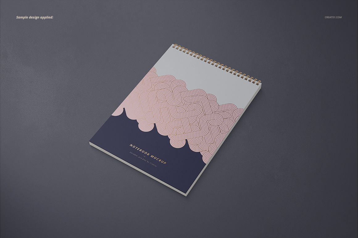 Mockup of an A4 vertical spiral notebook featuring a wavy pink and navy design, shown in perspective on a dark background.