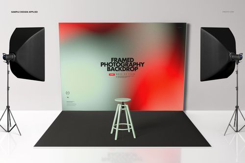 Photography backdrop mockup scene with a large framed backdrop featuring a blurred red and green design, two studio lights, and a stool.
