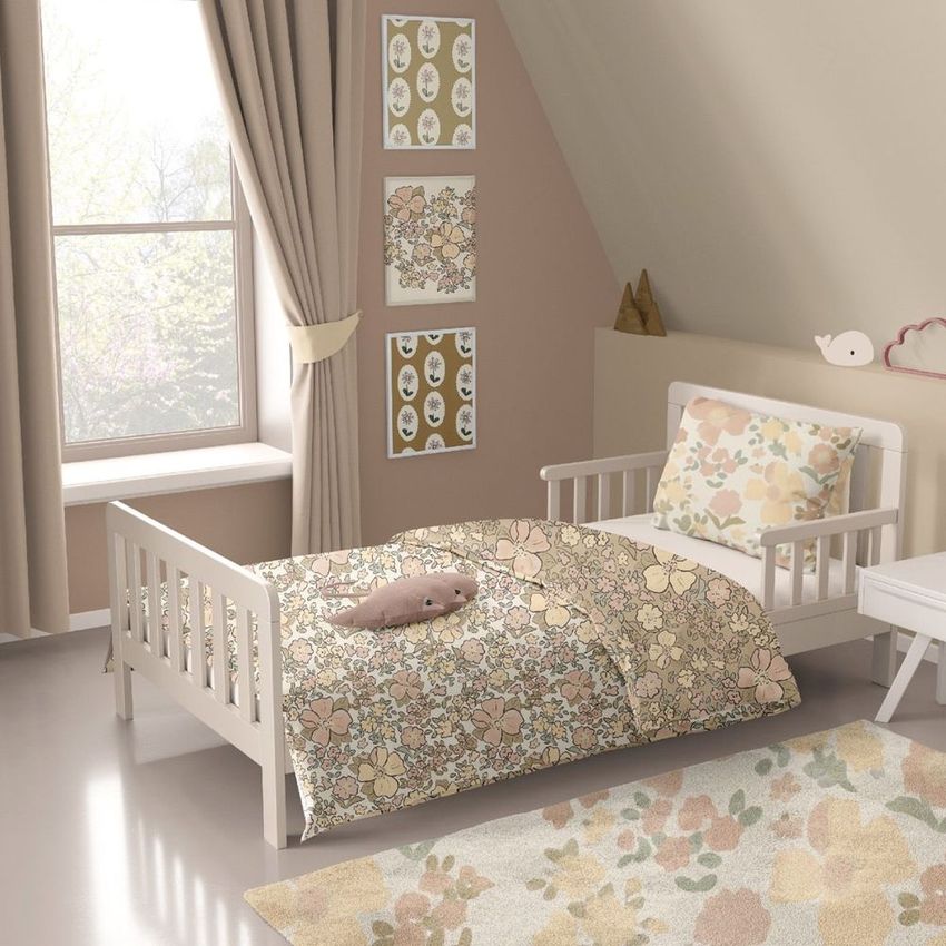 Toddler room bedding mockup featuring a white bed with floral patterned duvet and pillow, pastel wall art, and soft natural light.