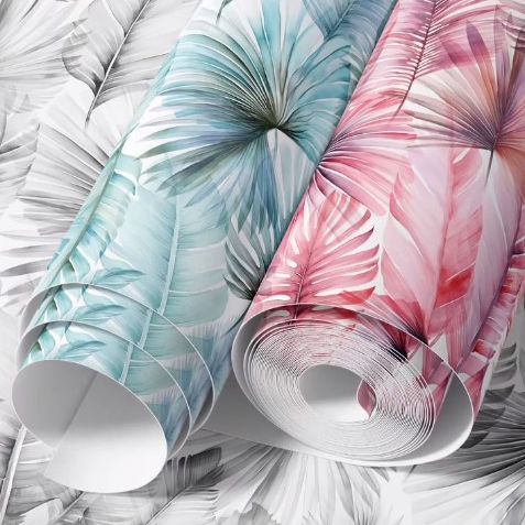 Paper wallpaper mockup featuring two rolled sheets with large palm leaf patterns in pastel blue and pink on a leaf-patterned background.