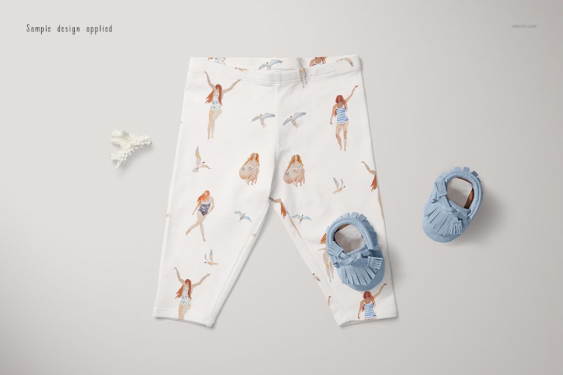 White baby leggings mockup featuring whimsical child and bird illustrations, shown from a top view with soft blue shoes nearby.