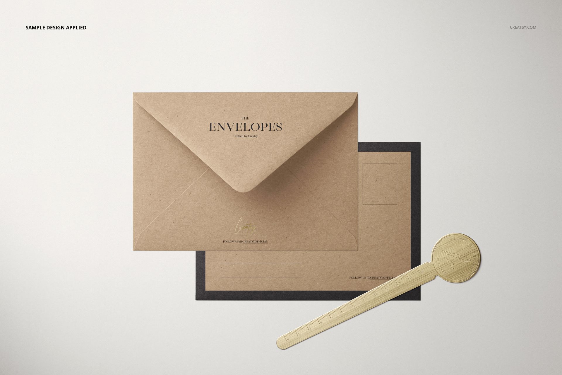 C6 kraft paper envelope mockup shown from above, paired with a postcard and a round wooden letter opener.