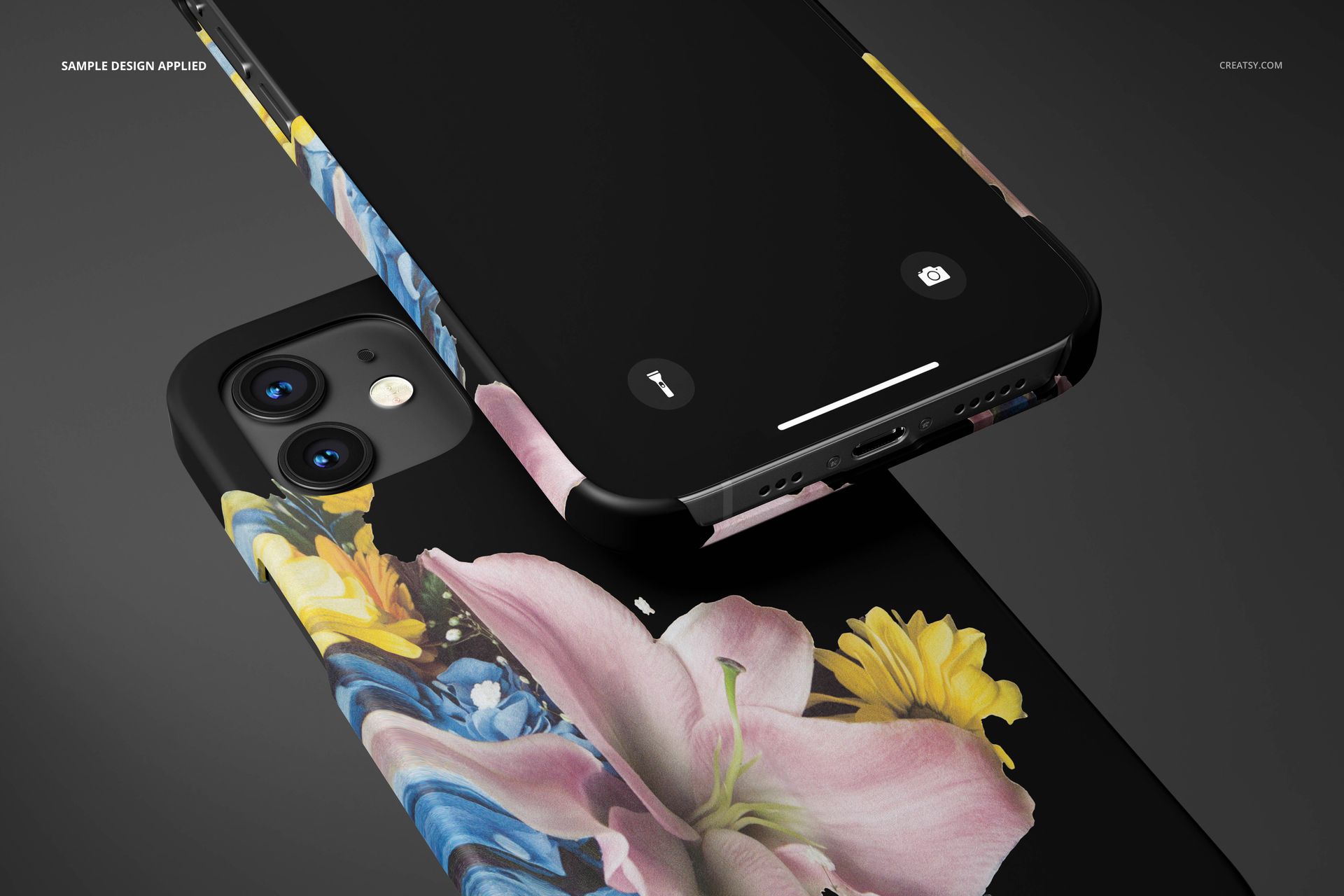 iPhone 12 matte snap case mockup featuring a floral design in pink, yellow, and blue on a black background, close-up view.