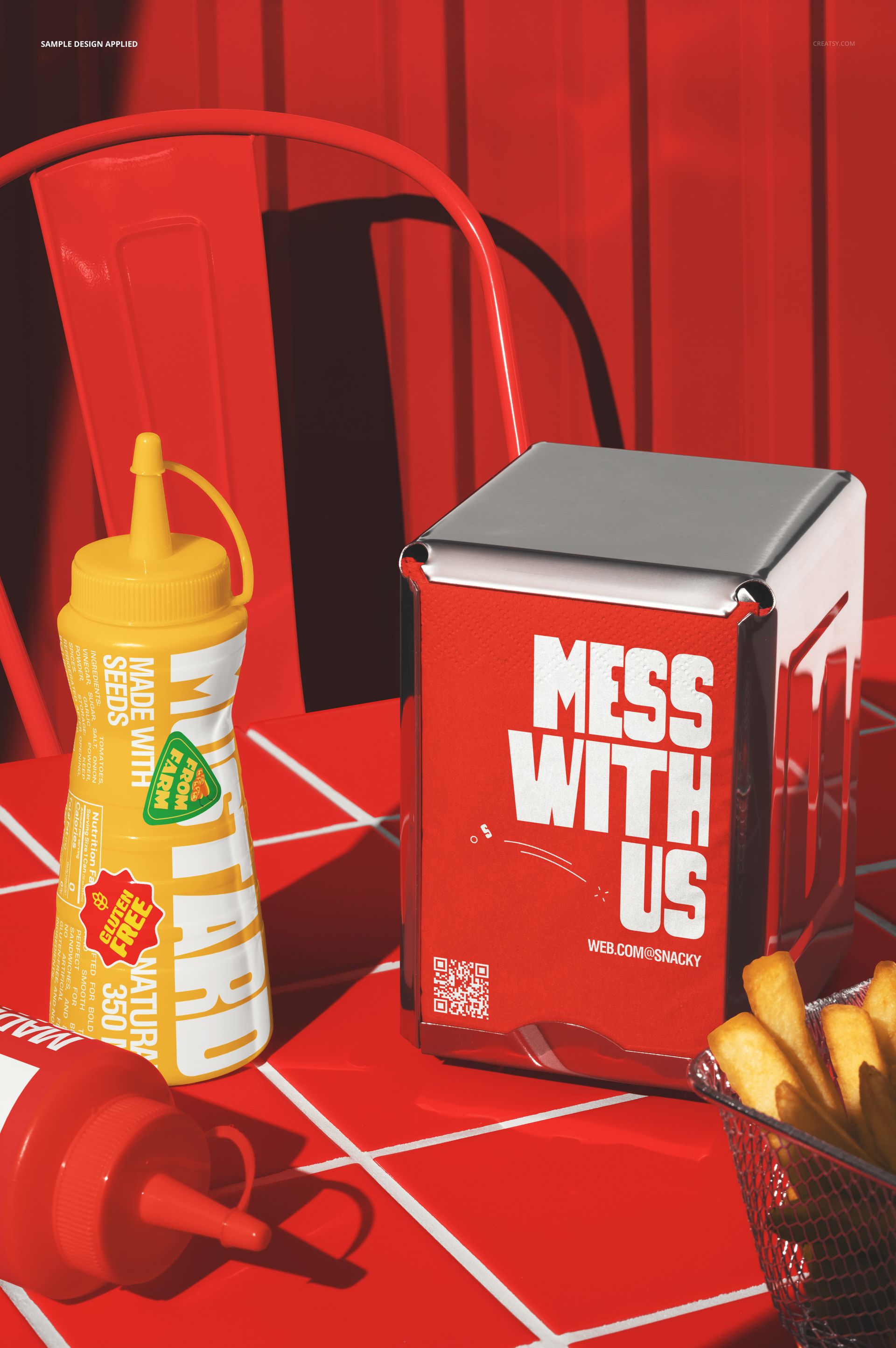 Front view of a fast food table setup with red and yellow condiment bottles, fries, and a napkin dispenser mockup.