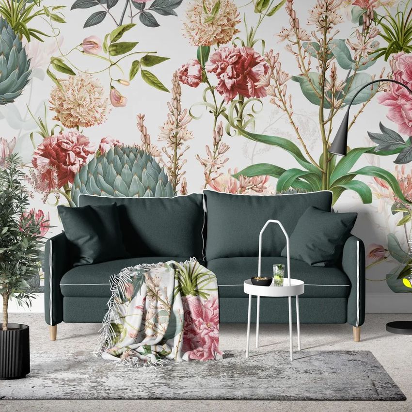 Sofa with pillows mockup in a living room setting, featuring a floral wallpaper with artichoke and pink flower patterns.