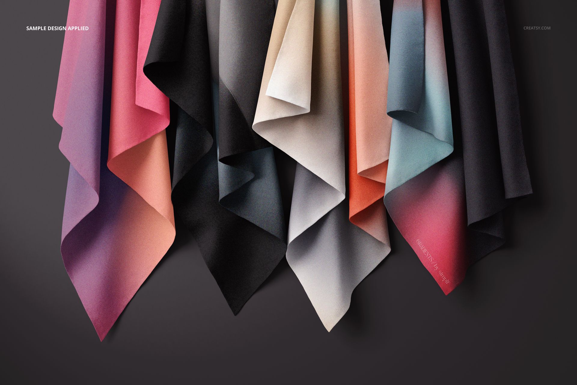 PSD mockup featuring draped textiles in various gradient hues, arranged vertically with a shadowed background.