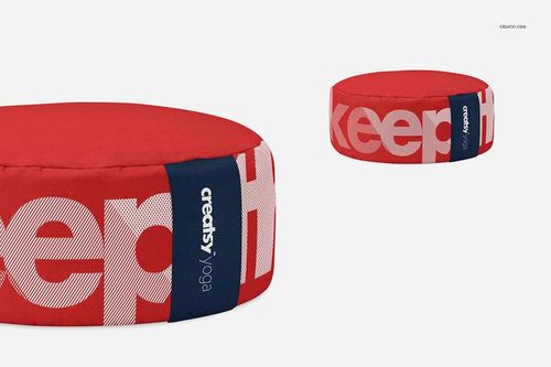 Meditation cushion mockup featuring a circular shape, red fabric top, and contrasting white lettering on the side.